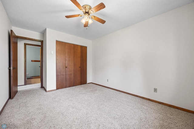 2802 29th Ave S, Moorhead, MN 56560 - unfurnished bedroom featuring light colored carpet, a closet, baseboards, and a ceiling fan