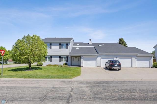 2802 29th Ave S, Moorhead, MN 56560 - colonial home featuring a front yard, a garage, driveway, and a chimney