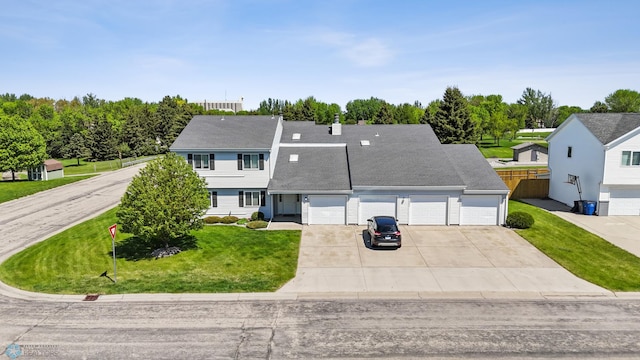 2802 29th Ave S, Moorhead, MN 56560 - view of front of property featuring driveway, a garage, roof with shingles, and view of wooded area