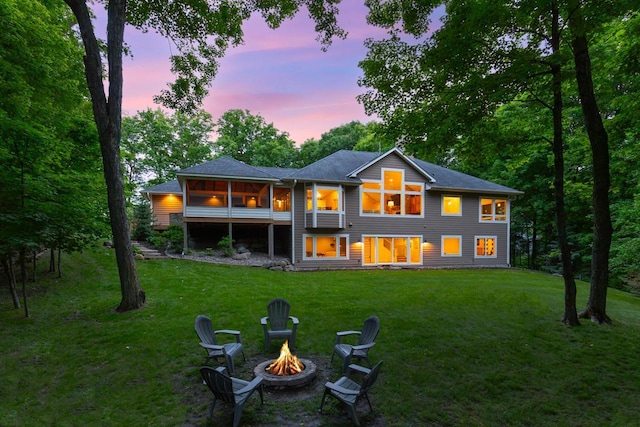 8580 Maple View Dr, Cologne, MN 55322 - back of house at dusk featuring a fire pit and a yard