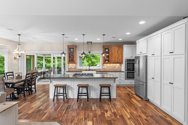 8580 Maple View Dr, Cologne, MN 55322 - kitchen featuring stainless steel appliances, glass insert cabinets, dark countertops, dark wood-type flooring, and recessed lighting
