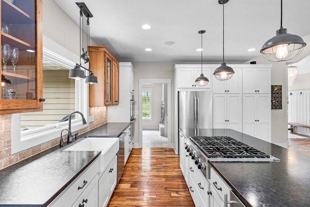 8580 Maple View Dr, Cologne, MN 55322 - kitchen featuring a sink, appliances with stainless steel finishes, backsplash, hardwood / wood-style floors, and decorative light fixtures