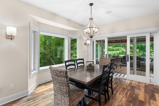 8580 Maple View Dr, Cologne, MN 55322 - dining room featuring healthy amount of natural light, a chandelier, wood finished floors, and baseboards