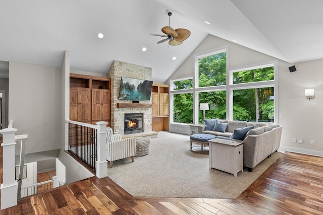 8580 Maple View Dr, Cologne, MN 55322 - living area with ceiling fan, high vaulted ceiling, a stone fireplace, baseboards, and wood finished floors