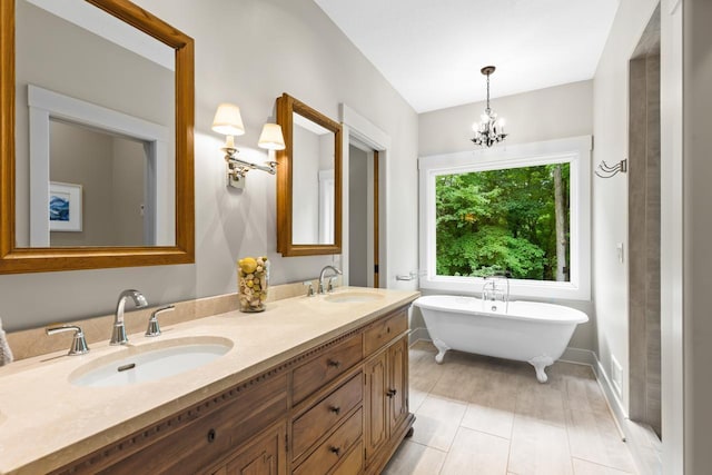 8580 Maple View Dr, Cologne, MN 55322 - bathroom with a soaking tub, double vanity, baseboards, and a chandelier