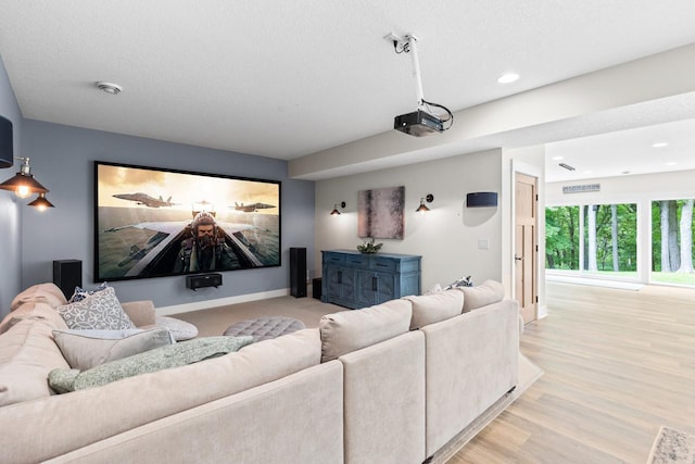 8580 Maple View Dr, Cologne, MN 55322 - cinema room featuring recessed lighting, light wood-style flooring, baseboards, and a textured ceiling