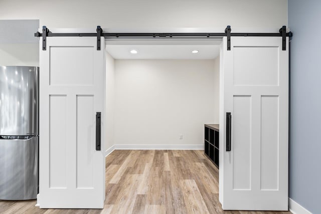 8580 Maple View Dr, Cologne, MN 55322 - kitchen with freestanding refrigerator, a barn door, light wood-style floors, baseboards, and recessed lighting