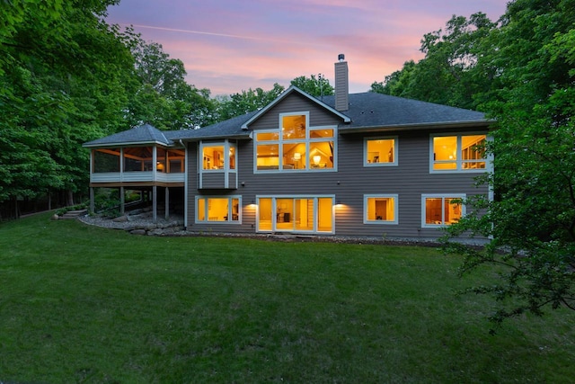 8580 Maple View Dr, Cologne, MN 55322 - back of house with a chimney, a sunroom, a lawn, and a shingled roof