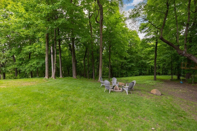 8580 Maple View Dr, Cologne, MN 55322 - view of grassy yard featuring a forest view and a fire pit