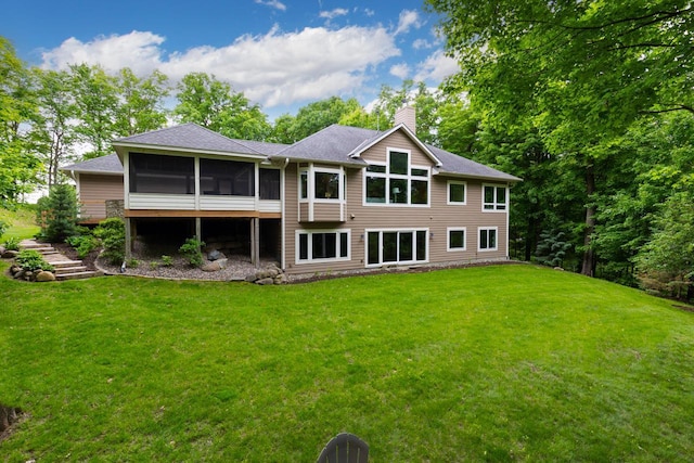 8580 Maple View Dr, Cologne, MN 55322 - rear view of house with a sunroom, a chimney, a lawn, and roof with shingles
