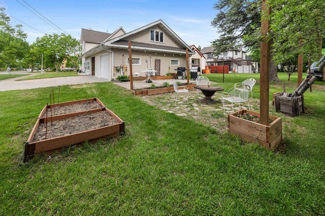 504 4th St, Brainerd, MN 56401 - back of property featuring a garden, driveway, an attached garage, and a lawn