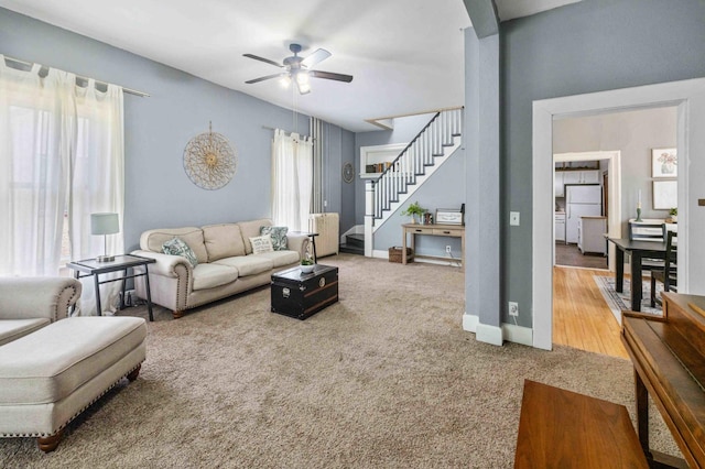 504 4th St, Brainerd, MN 56401 - carpeted living room with stairway, ceiling fan, and baseboards