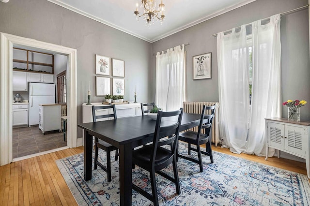 504 4th St, Brainerd, MN 56401 - dining space with a chandelier, light wood-style flooring, and ornamental molding