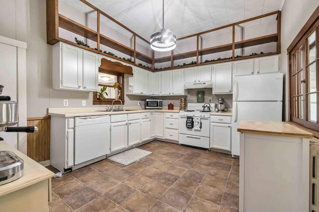 504 4th St, Brainerd, MN 56401 - kitchen featuring white appliances, under cabinet range hood, a sink, stone finish flooring, and white cabinets