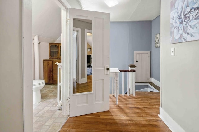 504 4th St, Brainerd, MN 56401 - corridor with wood finished floors, baseboards, and vaulted ceiling