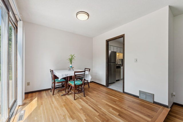 7674 Ideal Ave S, Cottage Grove, MN 55016 - dining room with light wood-style flooring and baseboards