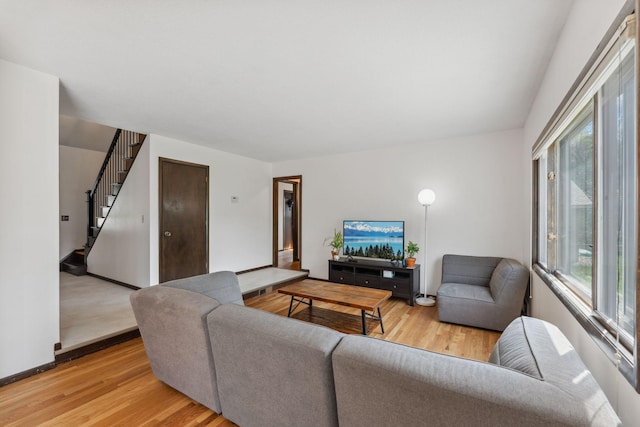 7674 Ideal Ave S, Cottage Grove, MN 55016 - living area with light wood-style floors, healthy amount of natural light, stairs, and baseboards