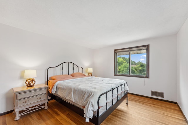 7674 Ideal Ave S, Cottage Grove, MN 55016 - bedroom featuring baseboards and light wood-style flooring