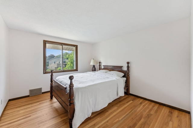 7674 Ideal Ave S, Cottage Grove, MN 55016 - bedroom with light wood-style flooring and baseboards