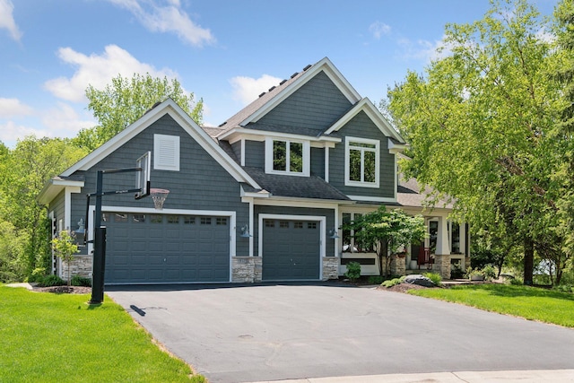 9375 Cold Stream Ln, Eden Prairie, MN 55347 - craftsman house featuring driveway, a front yard, stone siding, and an attached garage