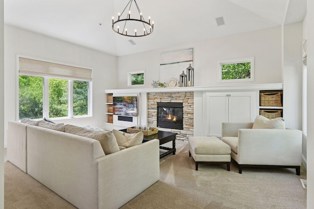 9375 Cold Stream Ln, Eden Prairie, MN 55347 - living area with light colored carpet, a chandelier, a stone fireplace, and plenty of natural light