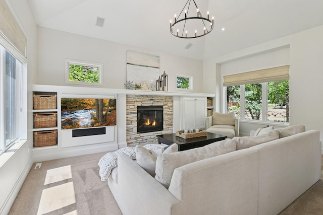9375 Cold Stream Ln, Eden Prairie, MN 55347 - carpeted living area with a towering ceiling, a chandelier, and a stone fireplace