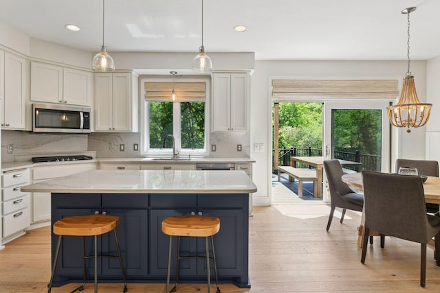 9375 Cold Stream Ln, Eden Prairie, MN 55347 - kitchen with stainless steel microwave, a sink, white cabinetry, and recessed lighting