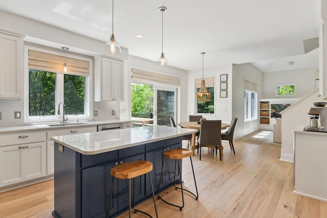 9375 Cold Stream Ln, Eden Prairie, MN 55347 - kitchen featuring a sink, white cabinetry, light wood finished floors, tasteful backsplash, and recessed lighting