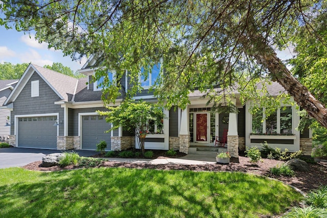 9375 Cold Stream Ln, Eden Prairie, MN 55347 - craftsman house featuring stone siding, asphalt driveway, an attached garage, and a front lawn