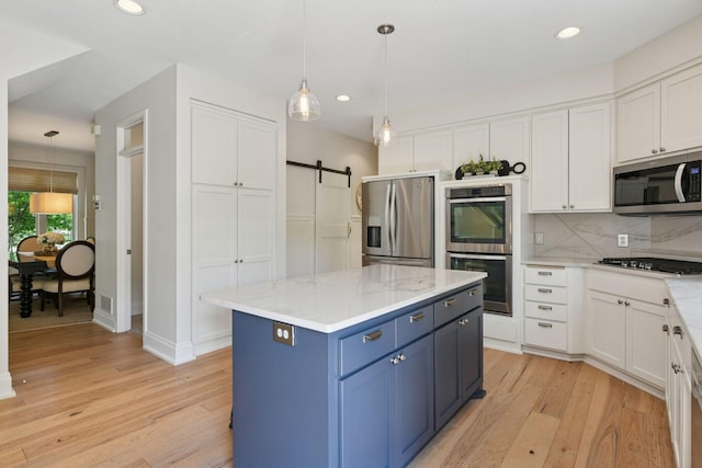 9375 Cold Stream Ln, Eden Prairie, MN 55347 - kitchen featuring stainless steel appliances, blue cabinets, white cabinetry, light wood-style flooring, and recessed lighting