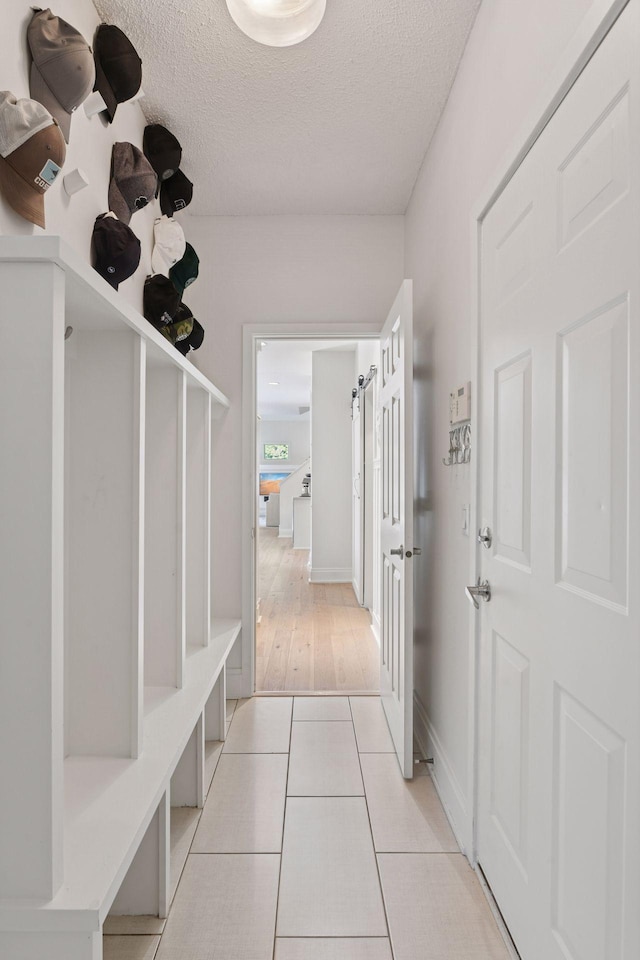 9375 Cold Stream Ln, Eden Prairie, MN 55347 - mudroom with a textured ceiling and light tile patterned flooring