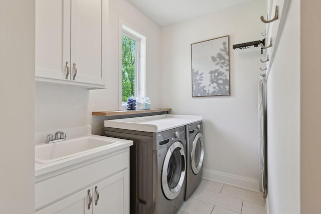9375 Cold Stream Ln, Eden Prairie, MN 55347 - washroom featuring washing machine and clothes dryer, cabinet space, baseboards, and light tile patterned floors
