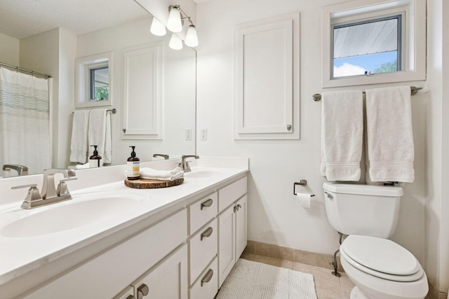 9375 Cold Stream Ln, Eden Prairie, MN 55347 - full bathroom with double vanity, tile patterned floors, toilet, baseboards, and plenty of natural light
