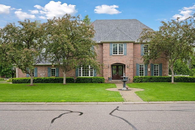 1511 Colleen Ave, Arden Hills, MN 55112 - view of front facade featuring french doors, a front yard, and brick siding