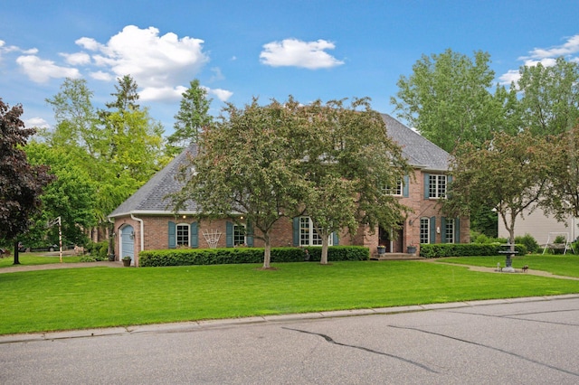 1511 Colleen Ave, Arden Hills, MN 55112 - view of front facade featuring a front lawn, brick siding, and a garage