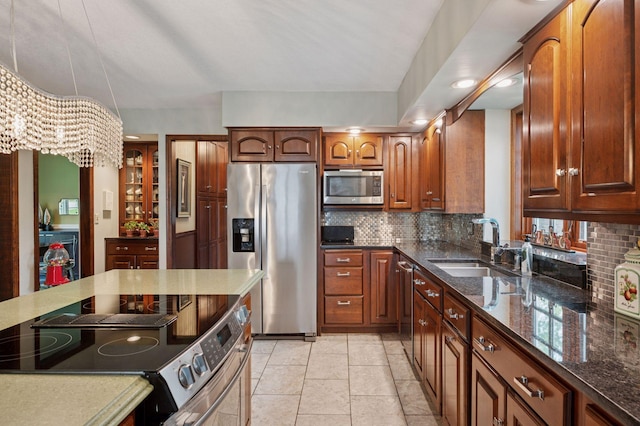1511 Colleen Ave, Arden Hills, MN 55112 - kitchen featuring stainless steel appliances, backsplash, dark stone counters, and a sink