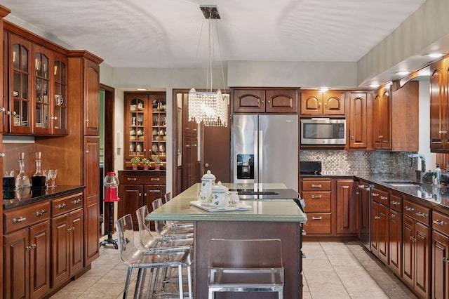 1511 Colleen Ave, Arden Hills, MN 55112 - kitchen with stainless steel appliances, a sink, tasteful backsplash, a chandelier, and light tile patterned floors