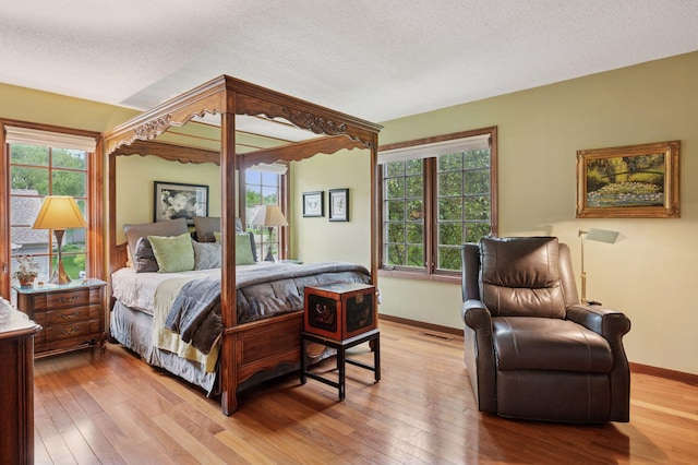 1511 Colleen Ave, Arden Hills, MN 55112 - bedroom featuring light wood-style floors, baseboards, and a textured ceiling