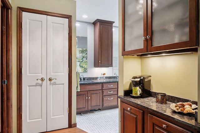 1511 Colleen Ave, Arden Hills, MN 55112 - kitchen featuring a sink, glass insert cabinets, dark stone countertops, recessed lighting, and light wood finished floors