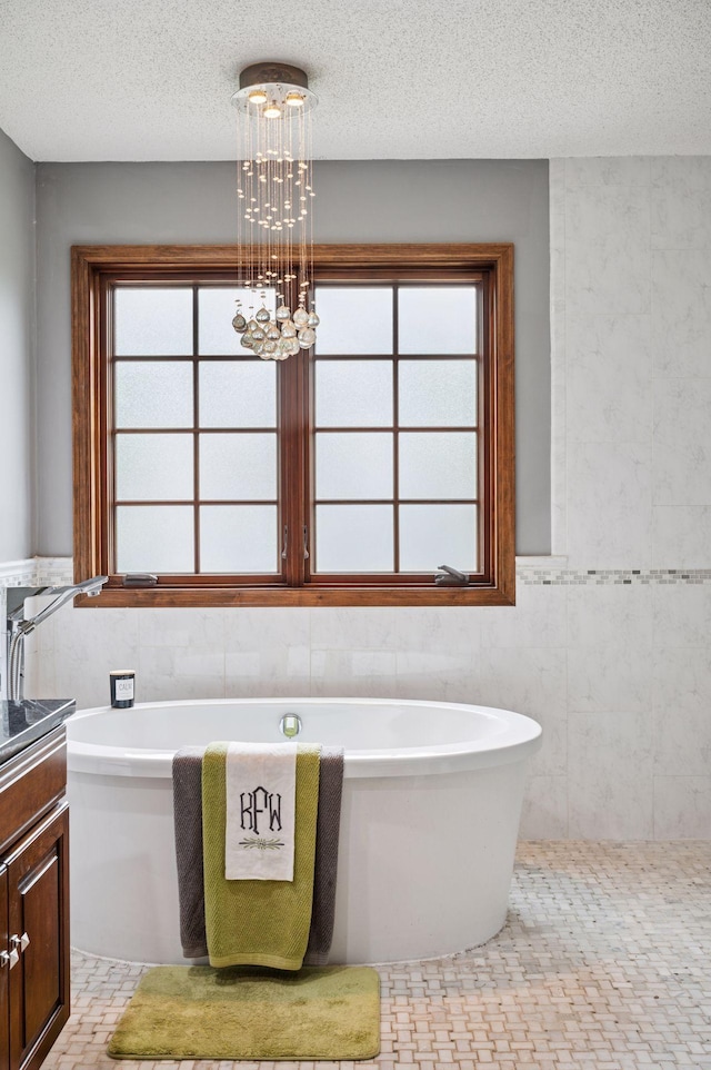1511 Colleen Ave, Arden Hills, MN 55112 - bathroom with tile walls, a freestanding tub, vanity, a chandelier, and healthy amount of natural light