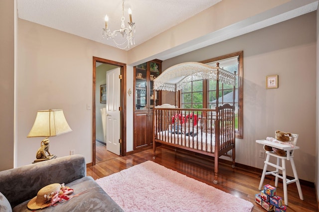 1511 Colleen Ave, Arden Hills, MN 55112 - bedroom with a chandelier, wood finished floors, and baseboards