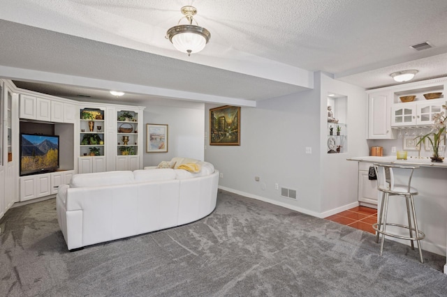 1511 Colleen Ave, Arden Hills, MN 55112 - living area with dark colored carpet, a textured ceiling, and baseboards
