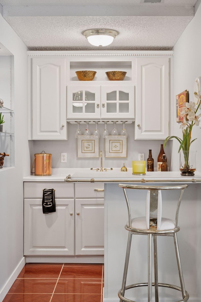 1511 Colleen Ave, Arden Hills, MN 55112 - kitchen with white cabinetry, a textured ceiling, light countertops, and a sink