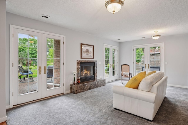 1511 Colleen Ave, Arden Hills, MN 55112 - living area featuring french doors, a textured ceiling, carpet flooring, a premium fireplace, and baseboards