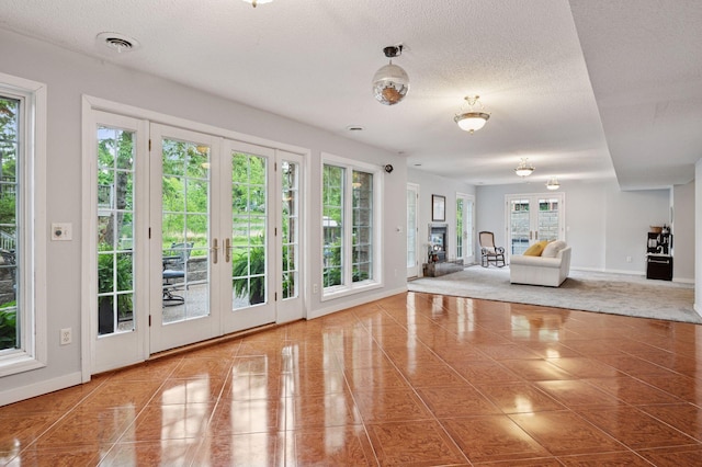 1511 Colleen Ave, Arden Hills, MN 55112 - doorway to outside featuring french doors, baseboards, tile patterned flooring, and a textured ceiling