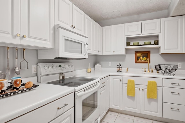 1511 Colleen Ave, Arden Hills, MN 55112 - kitchen featuring white appliances, a sink, white cabinets, light countertops, and a textured ceiling