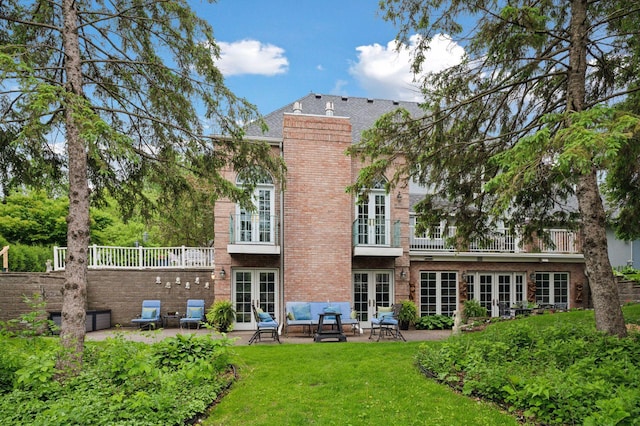 1511 Colleen Ave, Arden Hills, MN 55112 - rear view of property featuring french doors, a yard, a patio area, brick siding, and a balcony