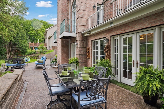 1511 Colleen Ave, Arden Hills, MN 55112 - view of patio / terrace featuring french doors, outdoor dining area, and a balcony