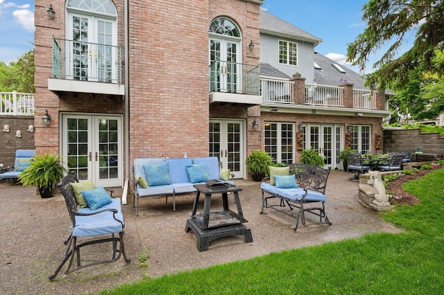 1511 Colleen Ave, Arden Hills, MN 55112 - back of house featuring french doors, a balcony, outdoor lounge area, and brick siding
