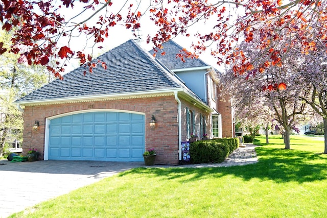 1511 Colleen Ave, Arden Hills, MN 55112 - view of side of home with a shingled roof, decorative driveway, a garage, brick siding, and a lawn